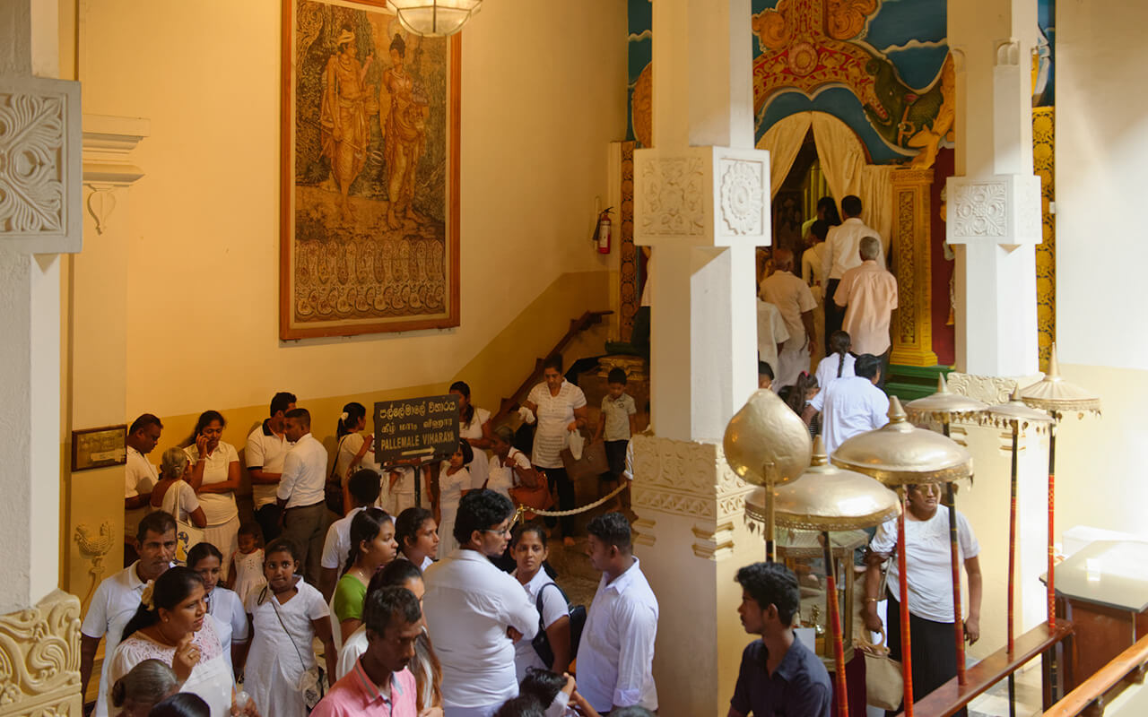 There are crowds of pilgrims at the Temple of Tooth in Kandy Sri Lanka