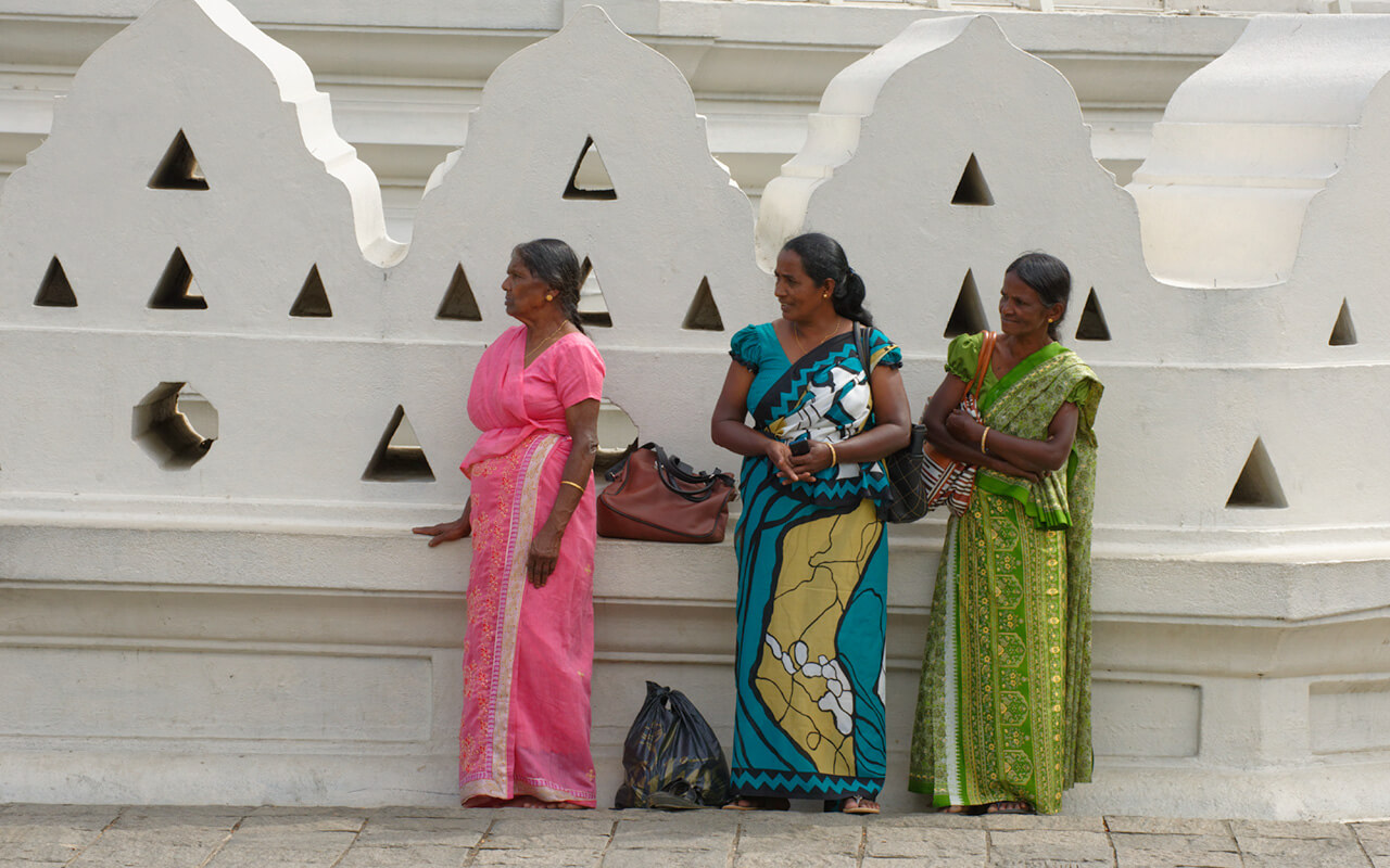 Sri Lankan women waiting outside the Temple of Tooth in Kandy Sri Lanka