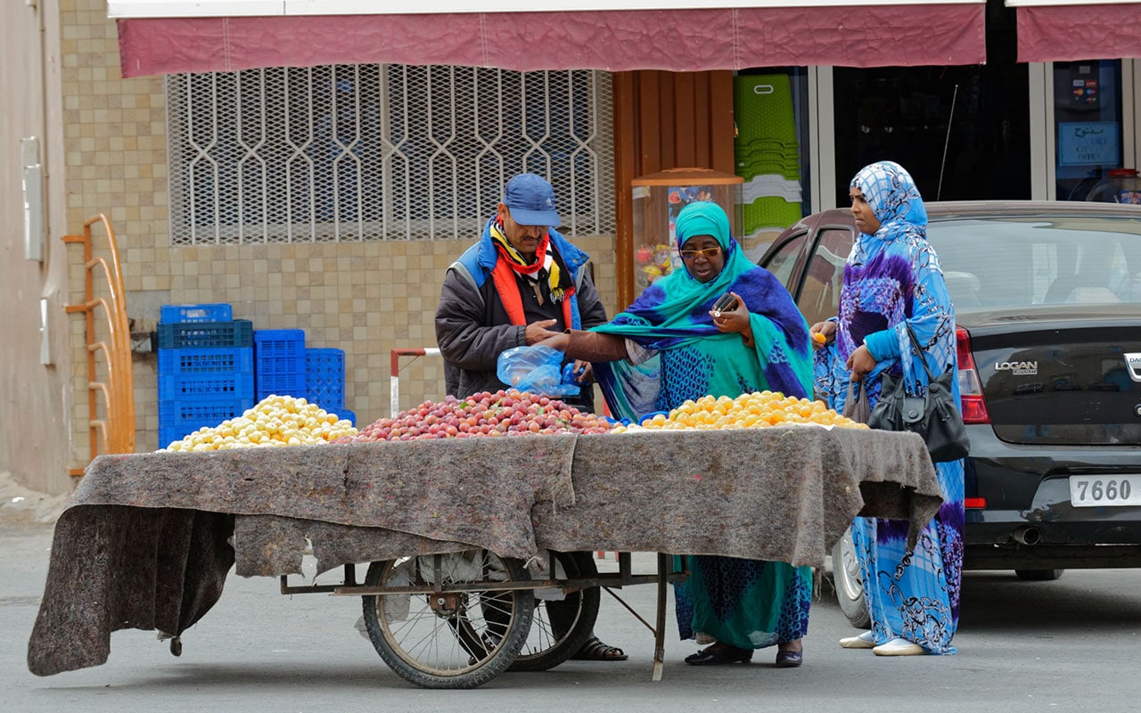 Southern women haggling over fruit in Morocco
