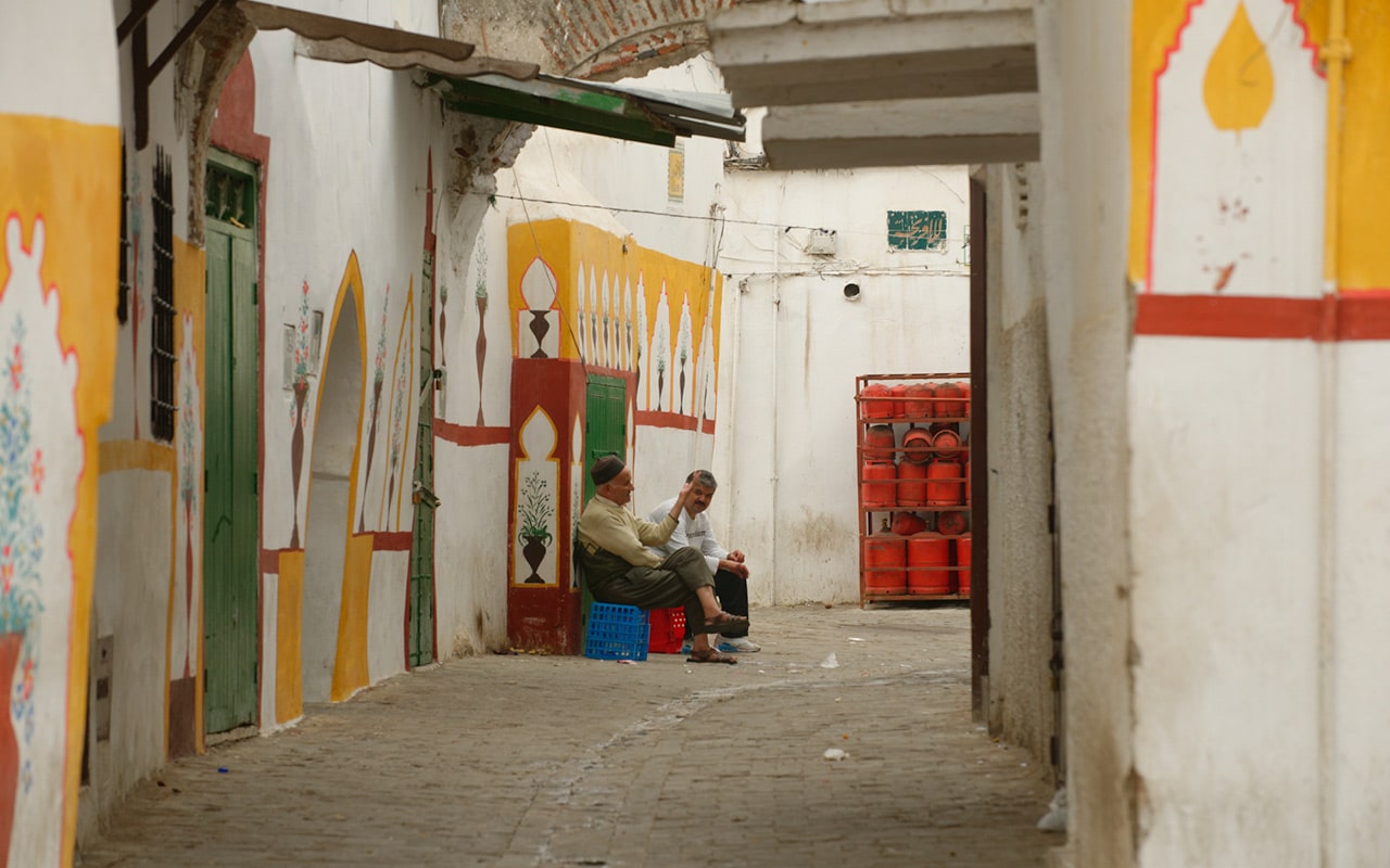 Two men sitting and talking make an interesting street photography scene in Morocco
