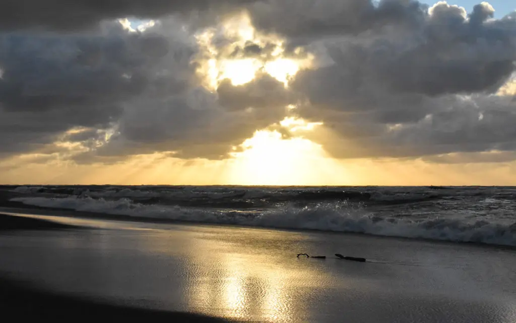 Watch the sunset on the beach at Hokitika