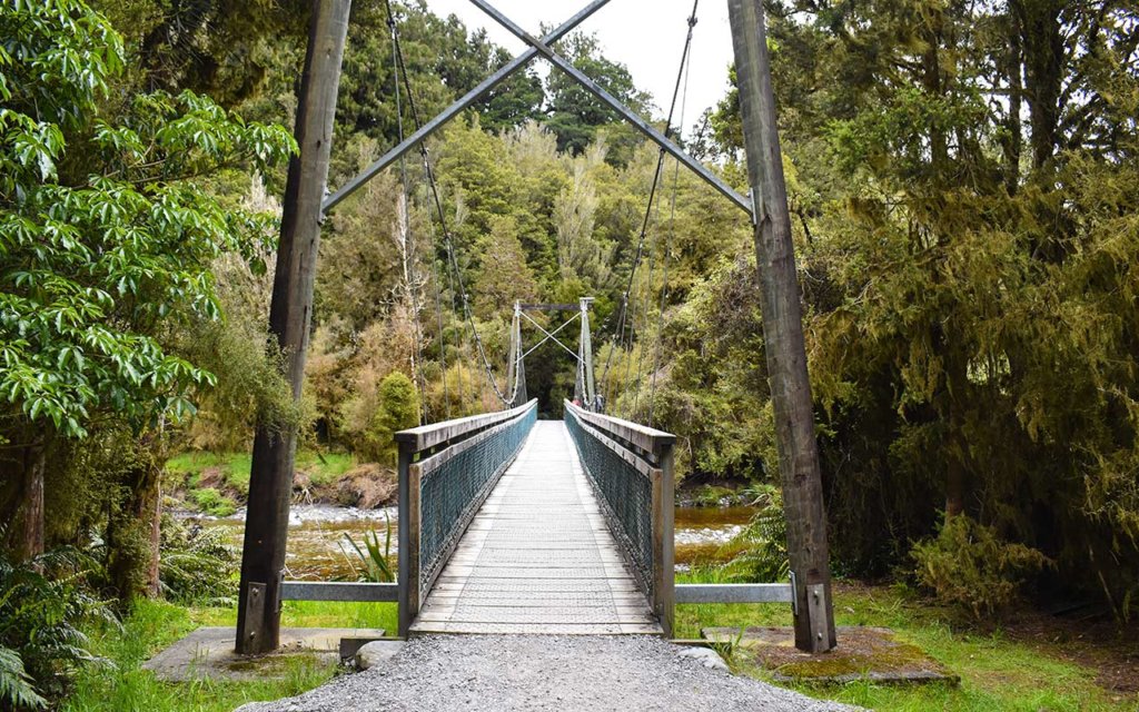 You need to cross a bridge at the start of the Lake Matheson circuit walk